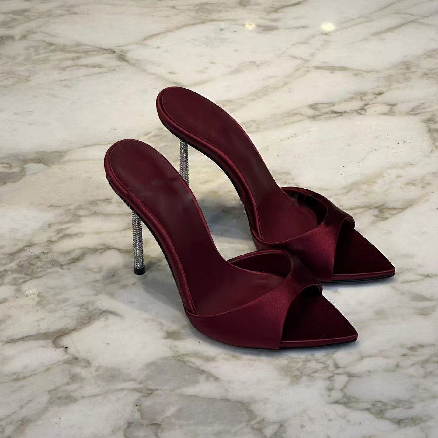High-end black satin pointed-toe sandals with rhinestone stiletto heels for women, perfect for wearing as outerwear.